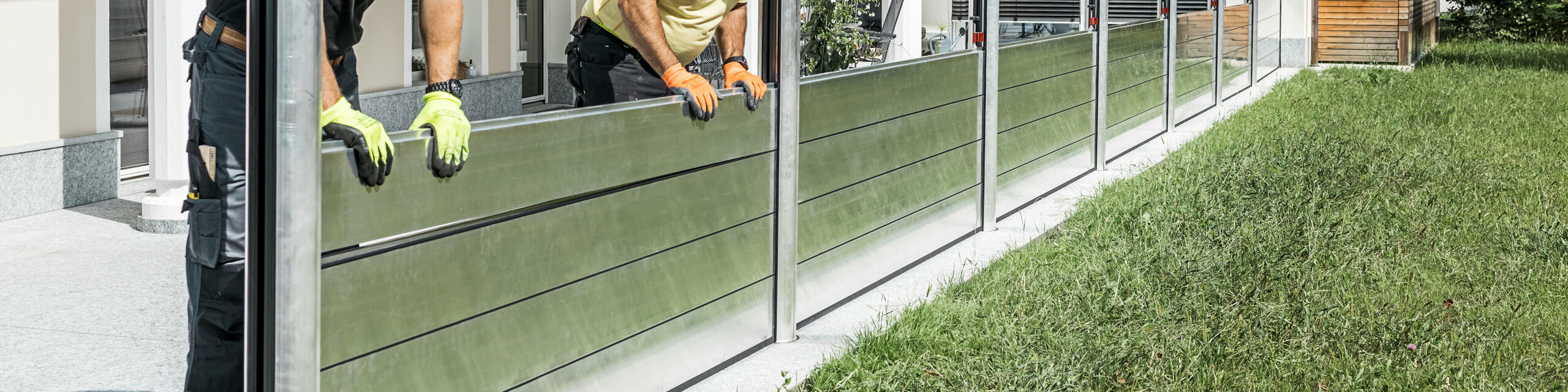 Die Aufnahme zeigt den mobilen Hochwasserschutz von PREFA, welcher das Einfamilienhaus im Hintergrund vor Hochwasser-Katastrophen schützt.